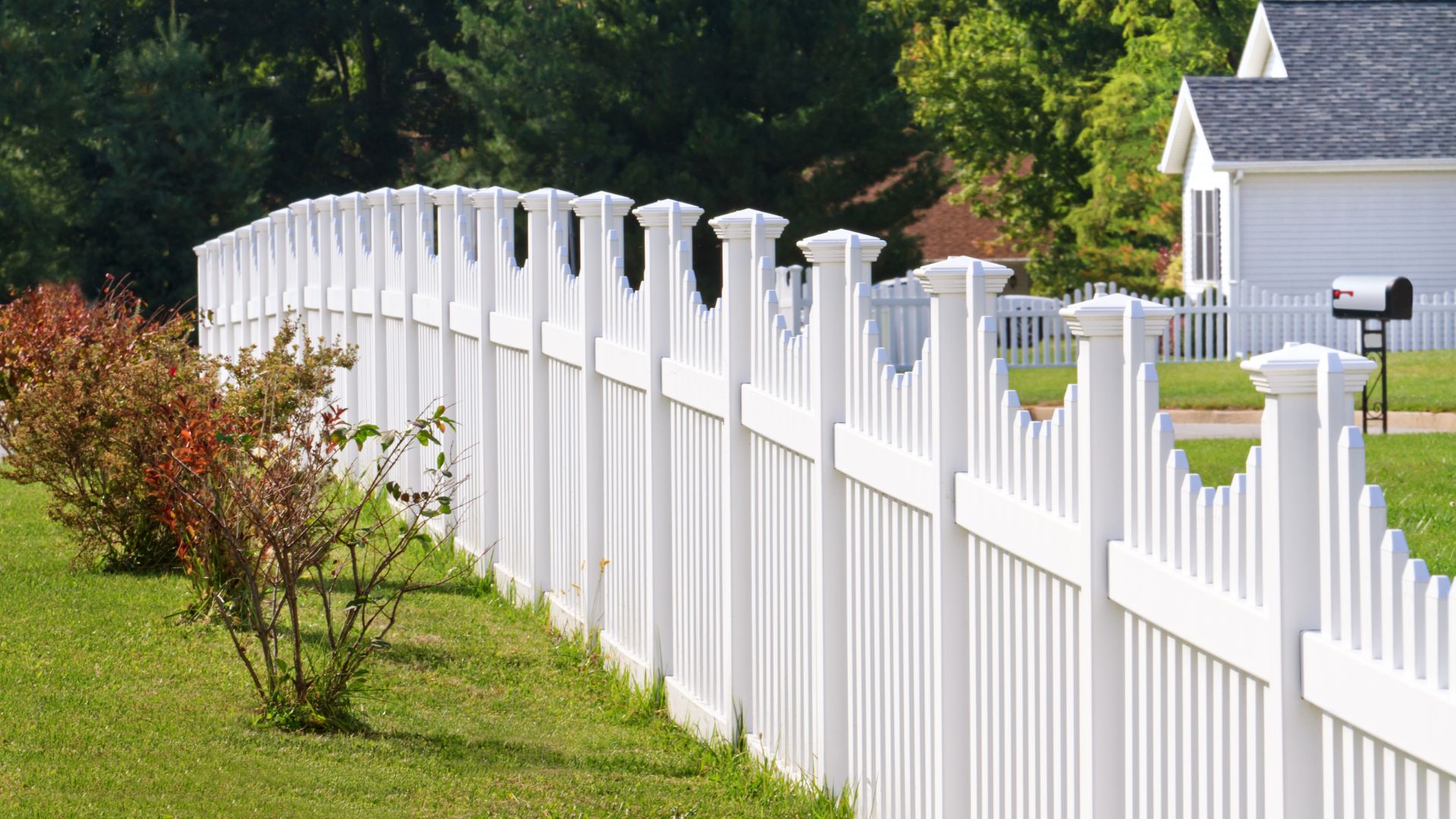 A white picket fence in front of a house