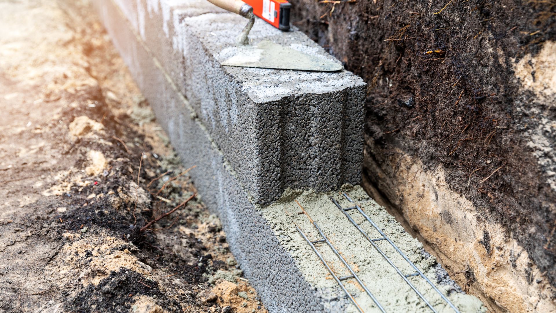 A cement block with a red and white sign sticking out of it