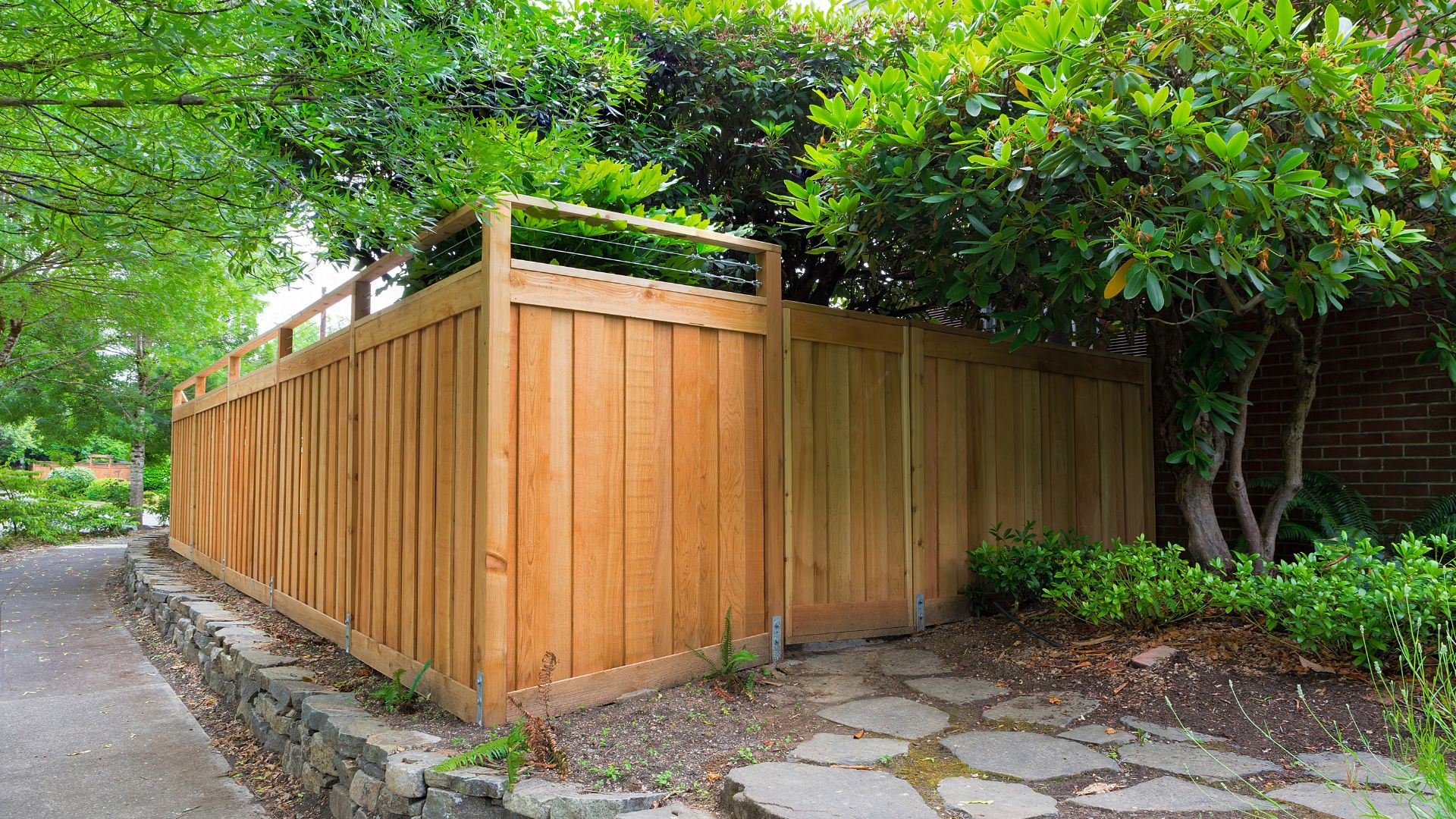 A wooden fence in the middle of a garden