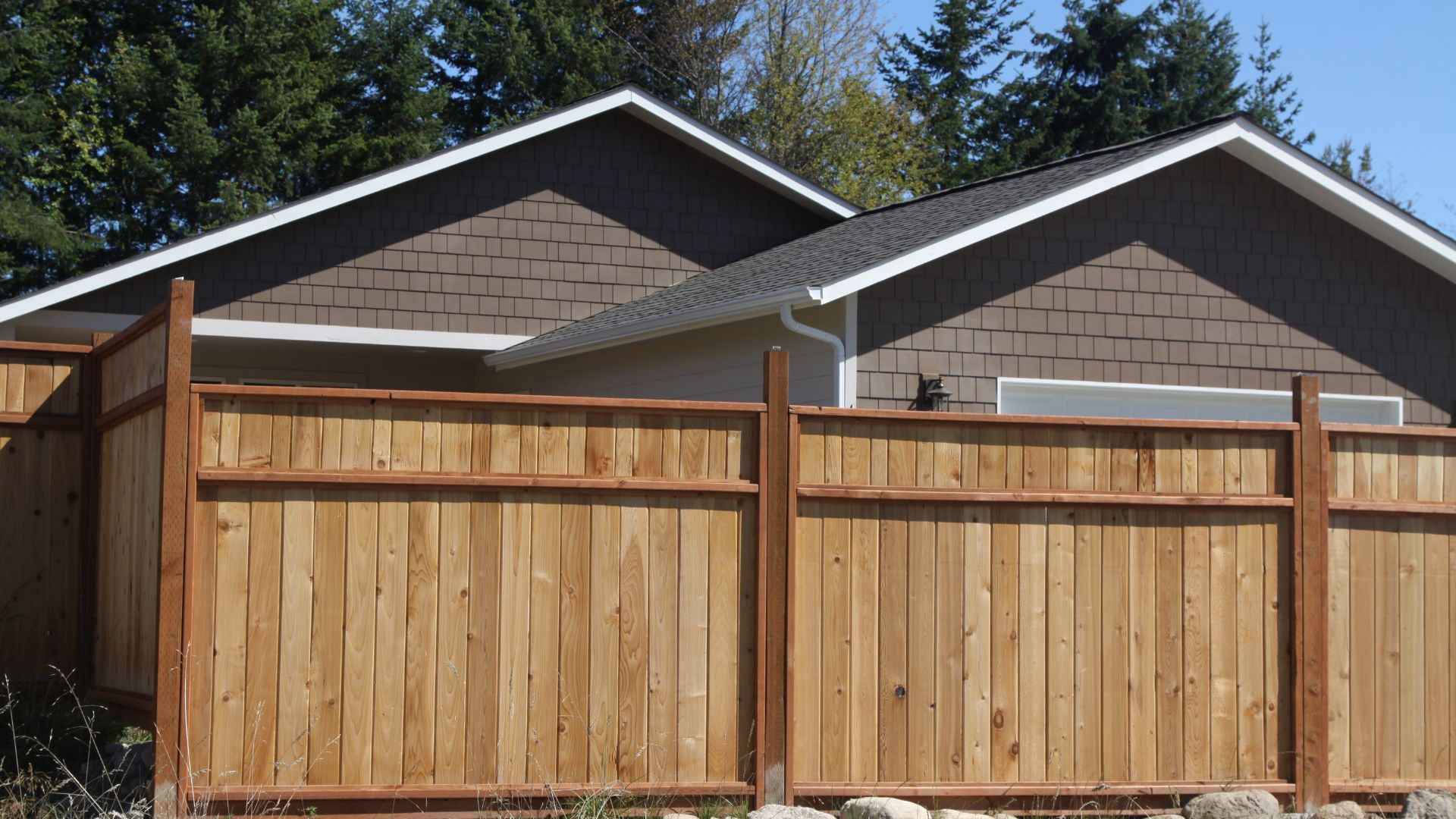 A wooden fence in front of a house